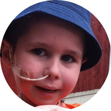 Mitchell Huth in a blue hat_smiling to camera_Mitchells Miracles_Neuroblastoma childrens cancer charity for the UK